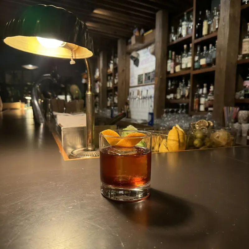 The American Trilogy cocktail, dim candlelight at Robin Room.