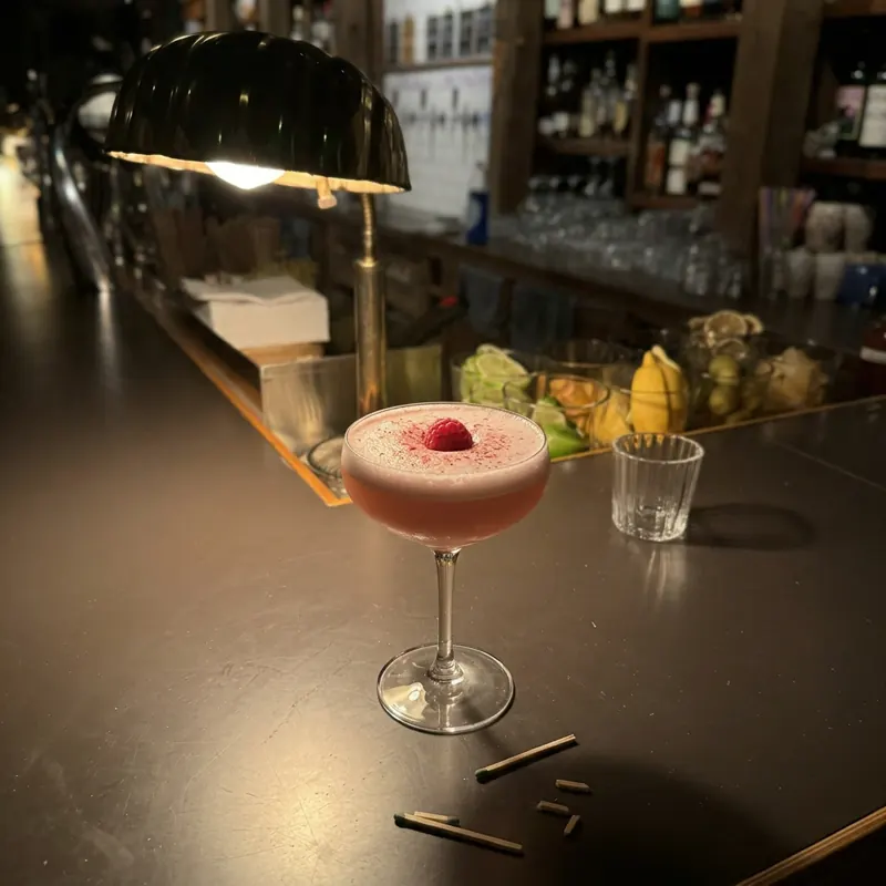 The Clover Club cocktail, dim candlelight at Robin Room.