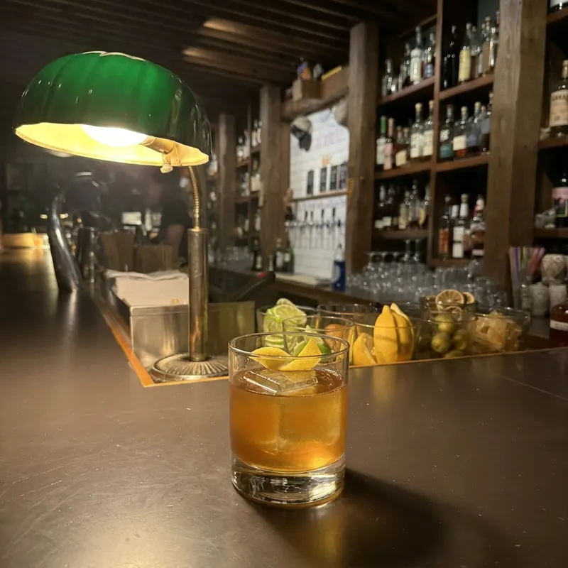 The Gold Rush cocktail, dim candlelight at Robin Room.