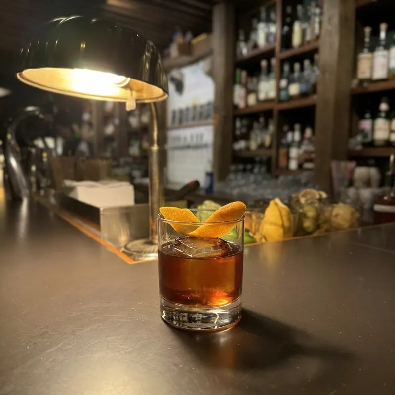The Oaxacan Old Fashioned cocktail, dim candlelight at Robin Room.