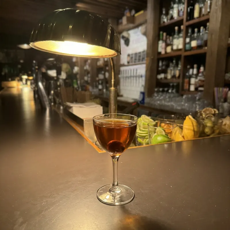 The Pass The Pigs cocktail, dim candlelight at Robin Room.